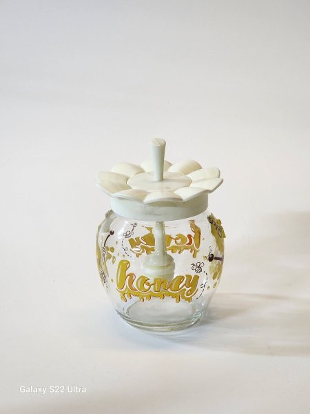 مرطبان زجاج عسل مع معلقة